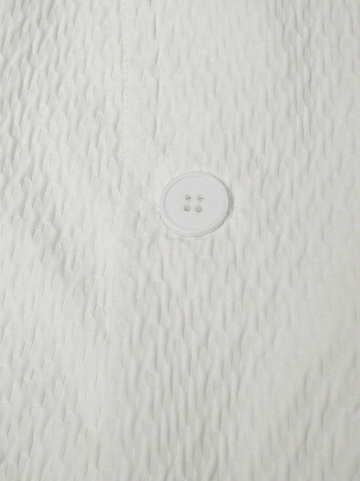 Detailed view of the blazer and shorts set showing tailoring and texture
