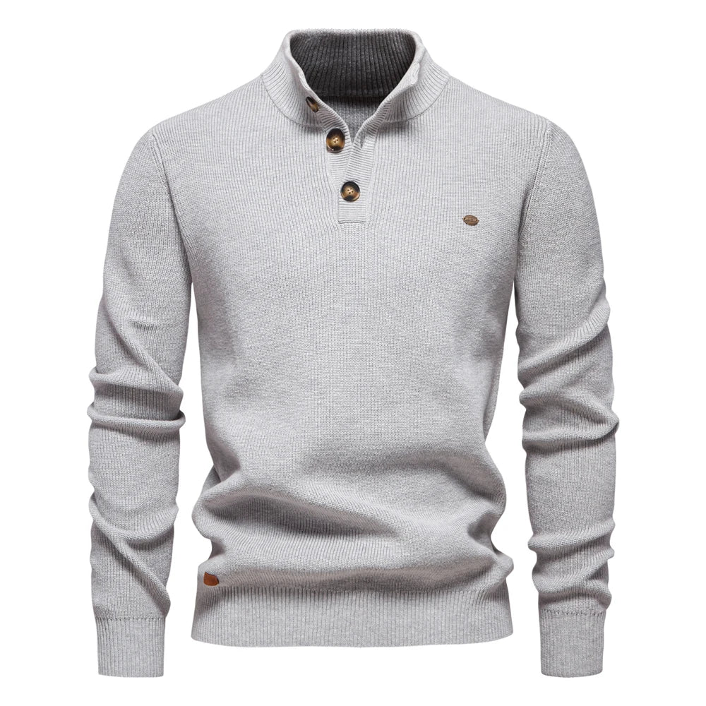 Detail of the neckline and button fastening on the jumper