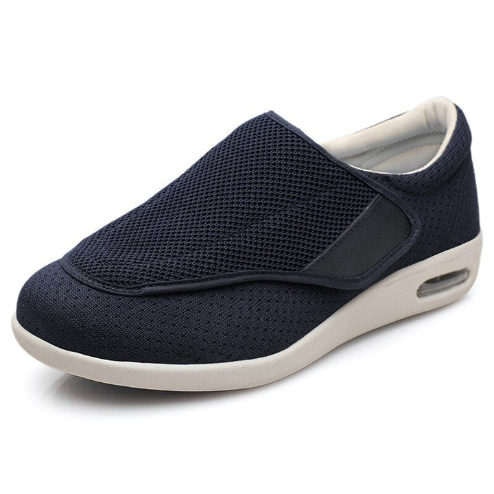 Rear view of men's wide fit comfort shoes on a plain background