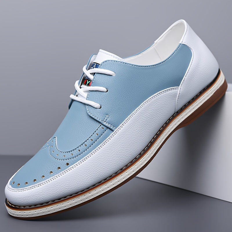 Men's two-tone brogue leather shoes shown as a pair on a white background