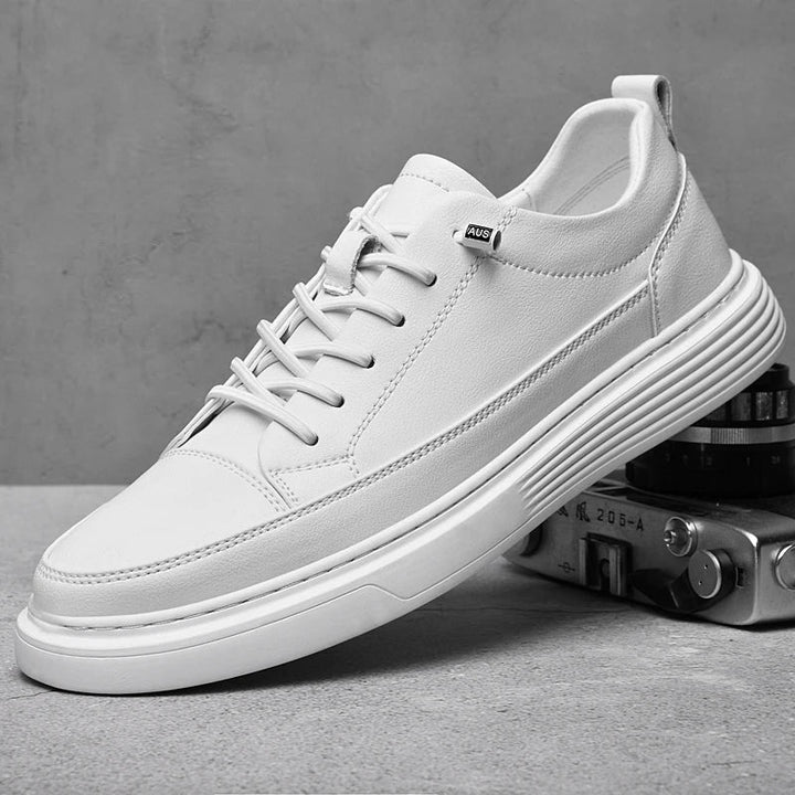 Men's white low-top leather sneakers shown from the side