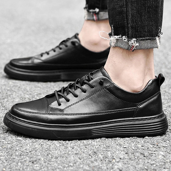 Top view of men's white leather sneakers showing laces and collar