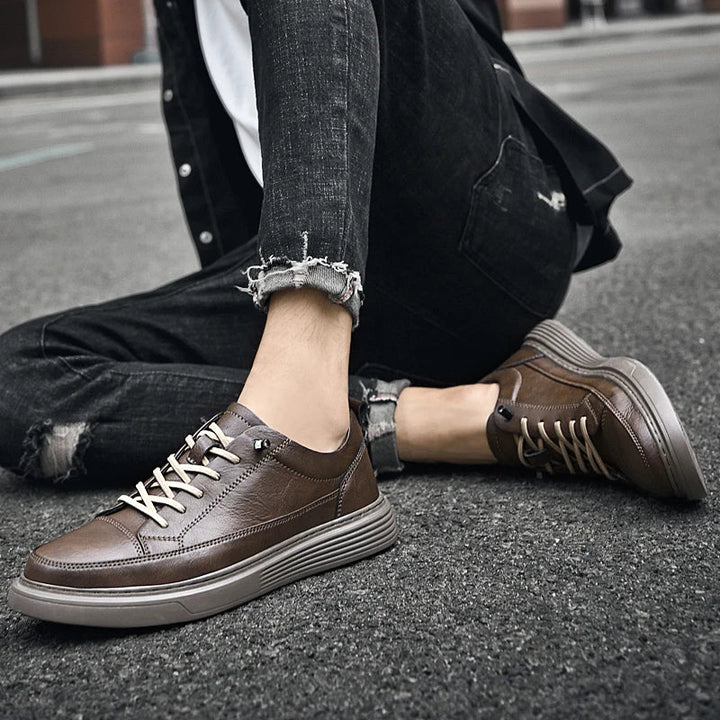 Men's white leather skate-style sneakers with clean minimalist design