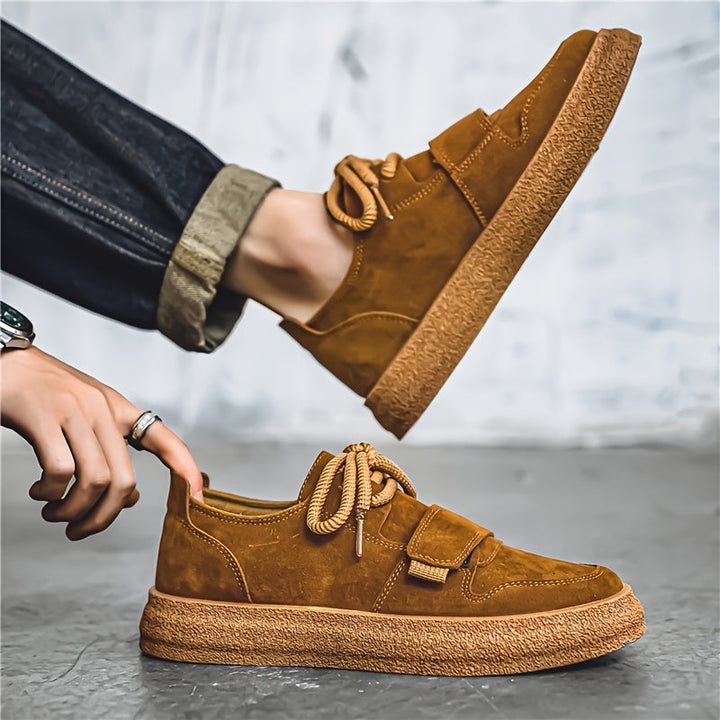 Side view of men's suede trainers with chunky sole and lace-up fastening