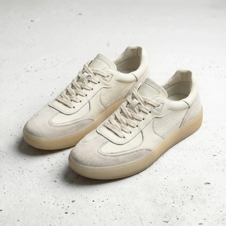 Pair of men's faux leather low top trainers with lace-up fastening