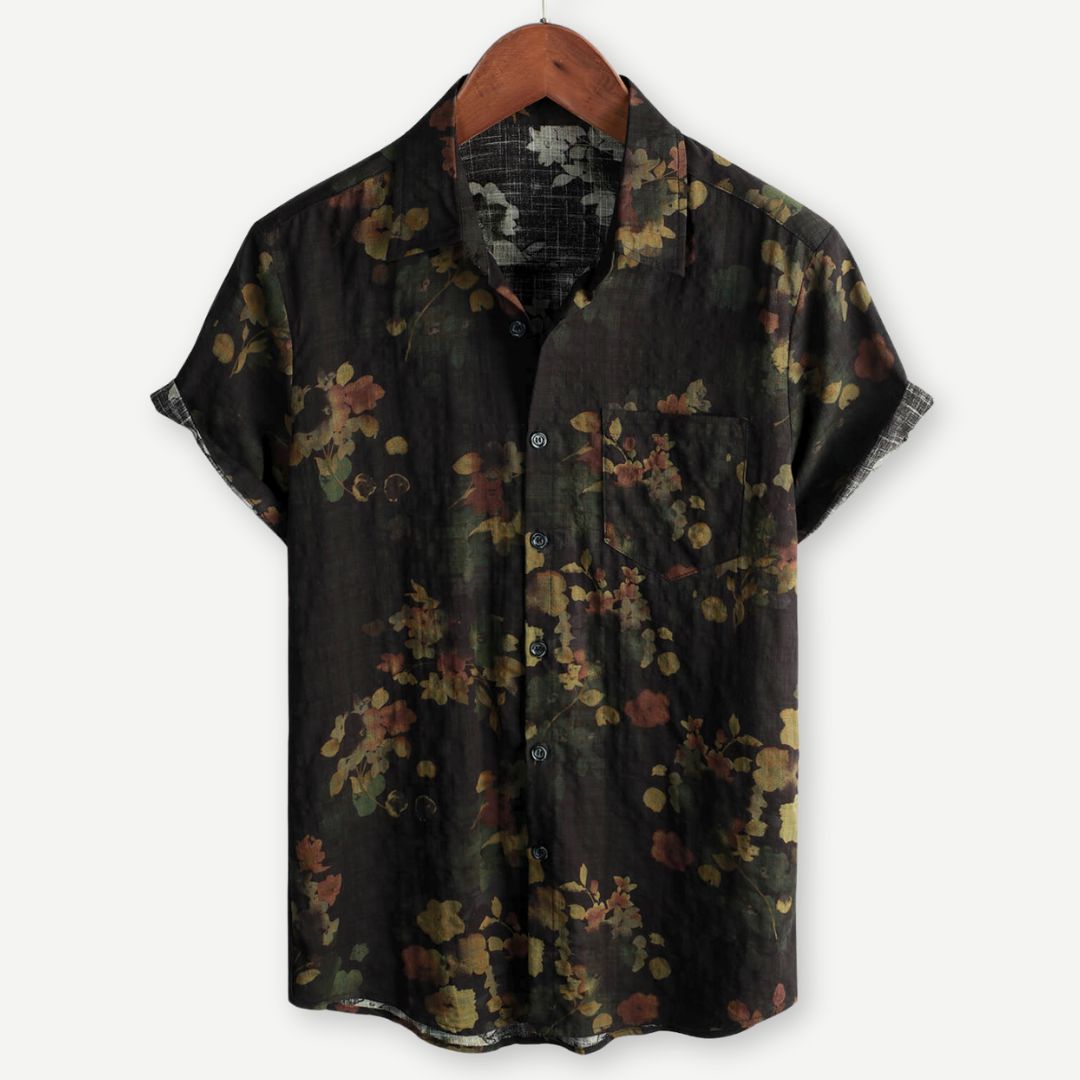 Men's floral print short sleeve shirt with button front on a plain background