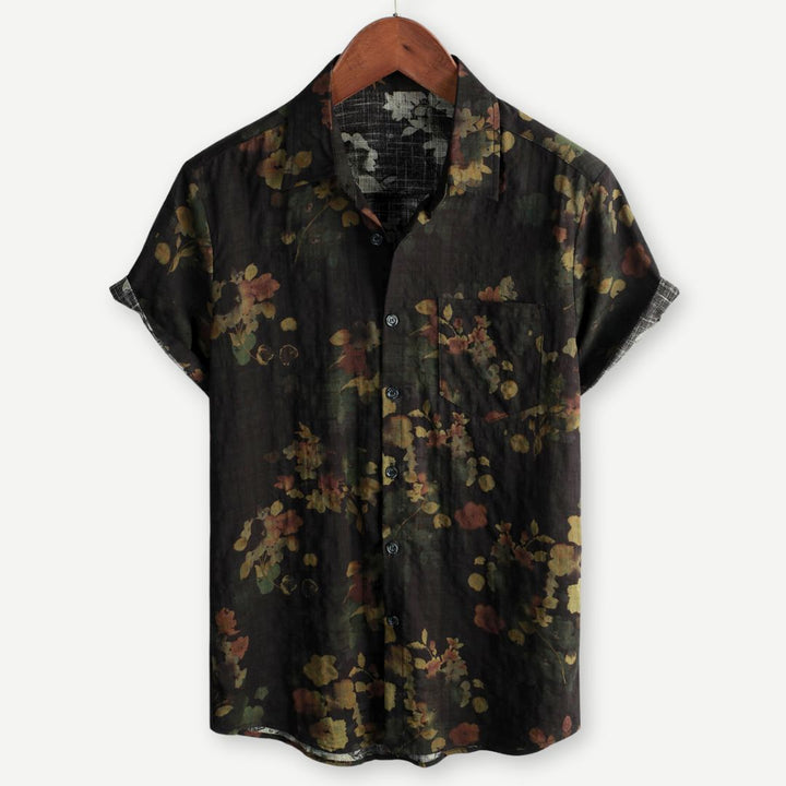 Men's floral print short sleeve shirt with button front on a plain background