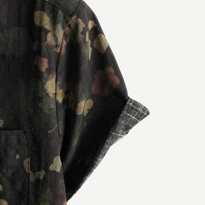 Angled view of men's floral print shirt styled for casual summer wear