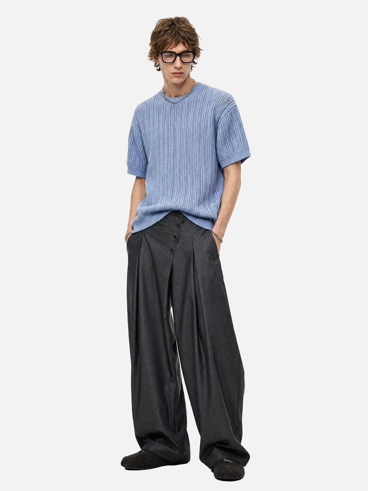 Men's lightweight open-knit top paired with casual trousers