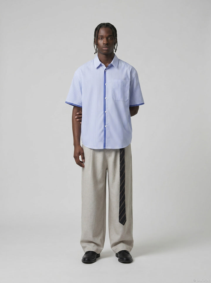 Close-up of short sleeve and striped pattern on men's blue shirt