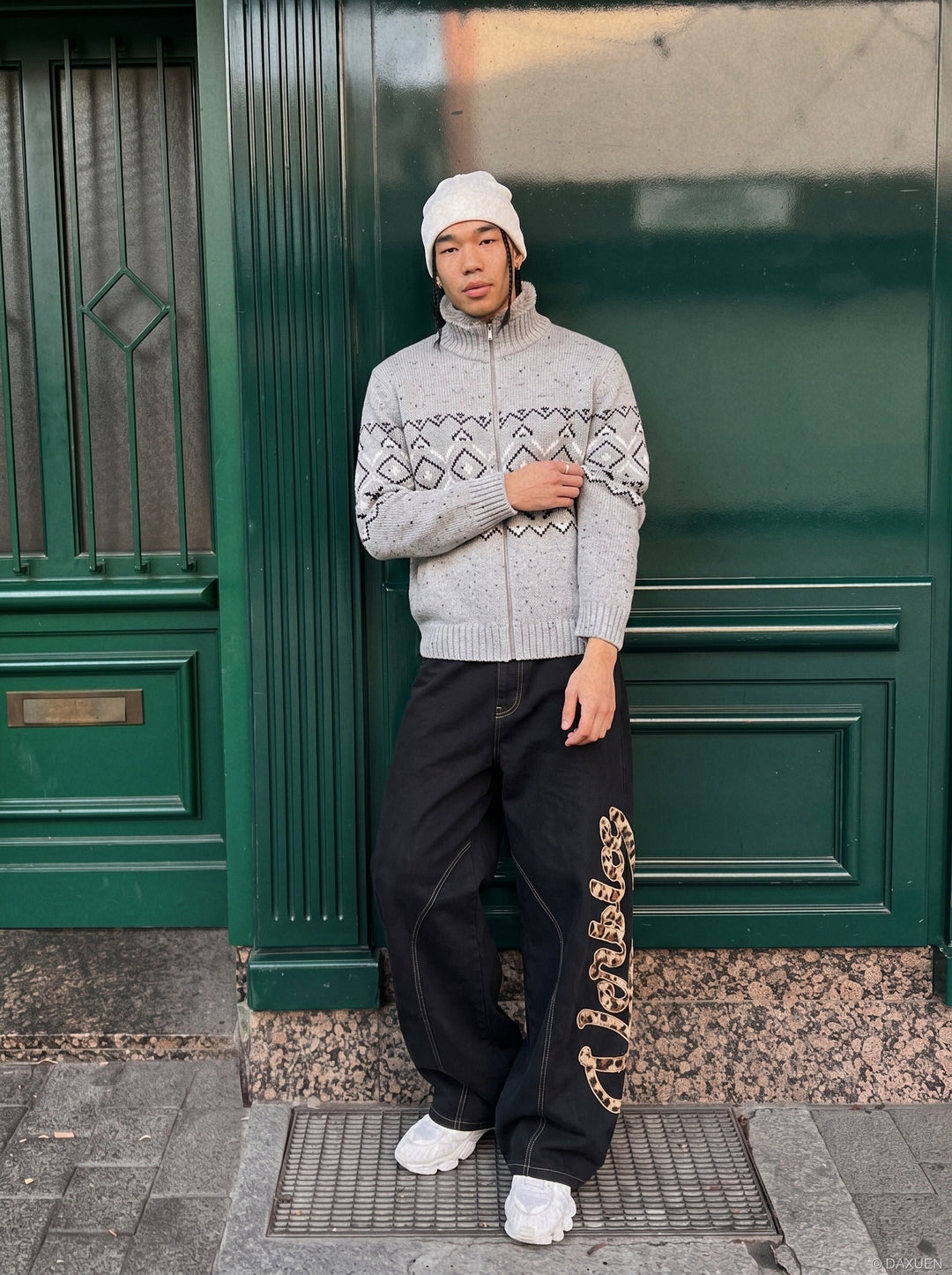 Front view of a men's geometric knit mock neck cardigan