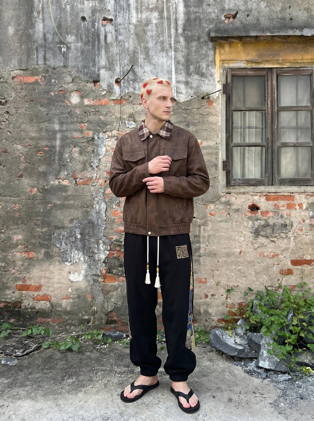 Angled view of men's leather bomber jacket with checked collar