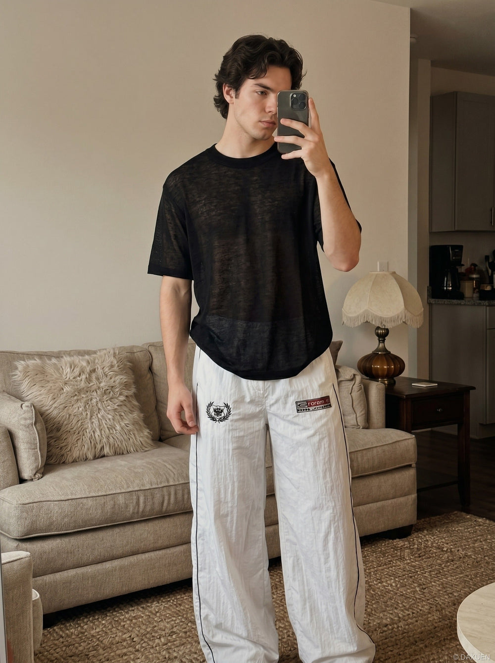Angled front view of black sheer knit crew neck T-shirt for men