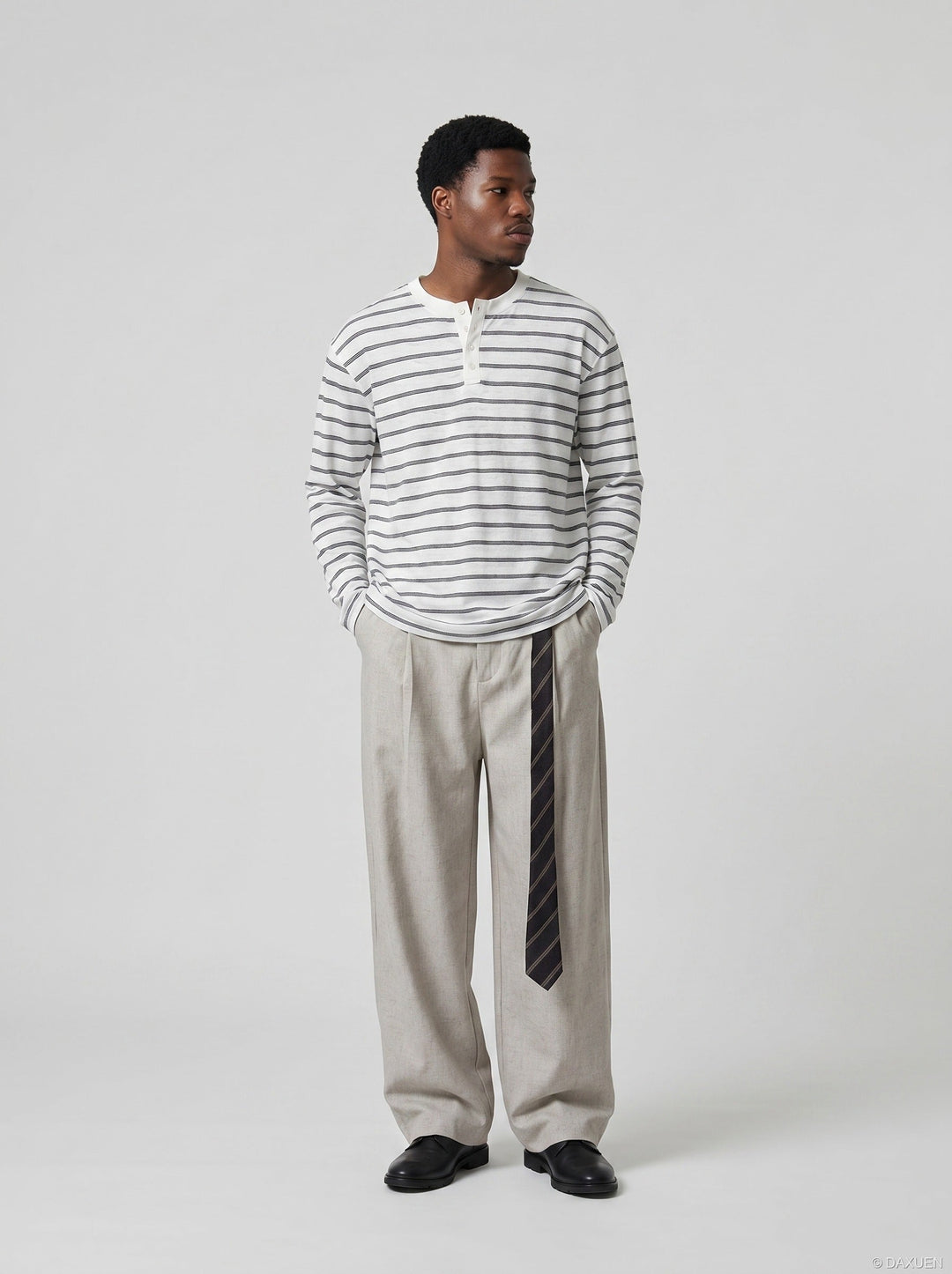 Close-up of sleeve and fabric detail on men's striped Henley shirt
