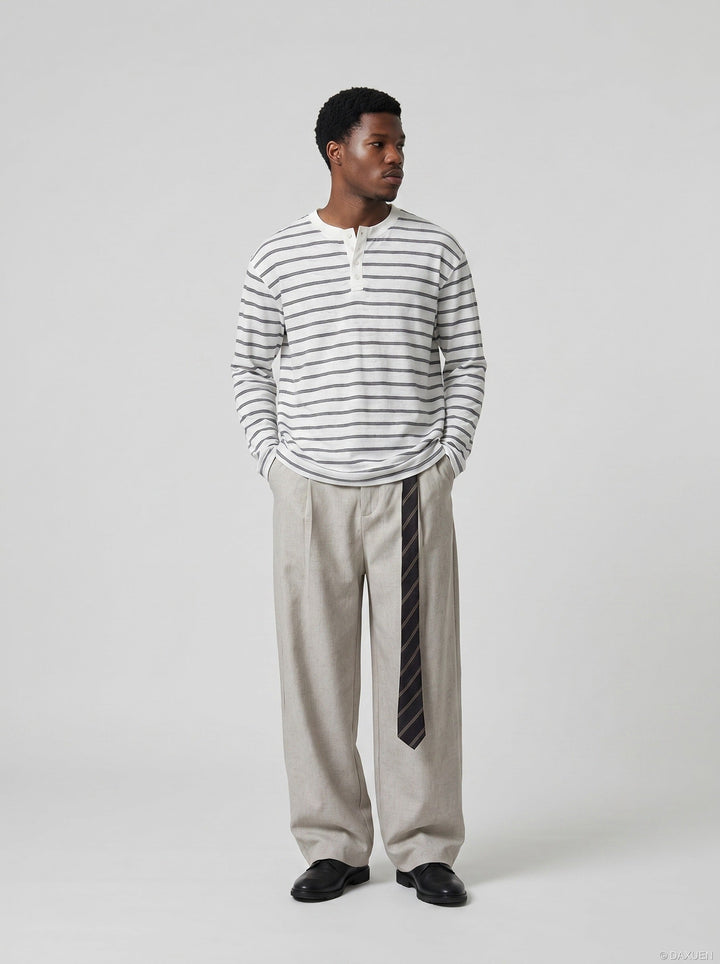 Close-up of sleeve and fabric detail on men's striped Henley shirt