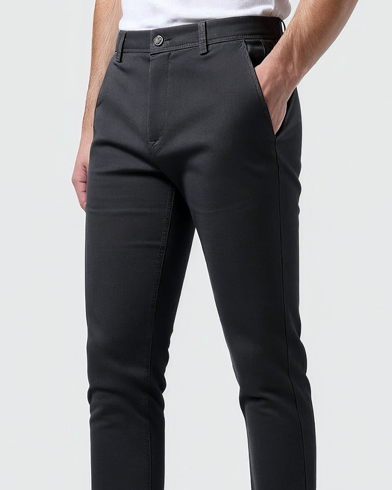 Full-length view of men's tapered chinos on a model