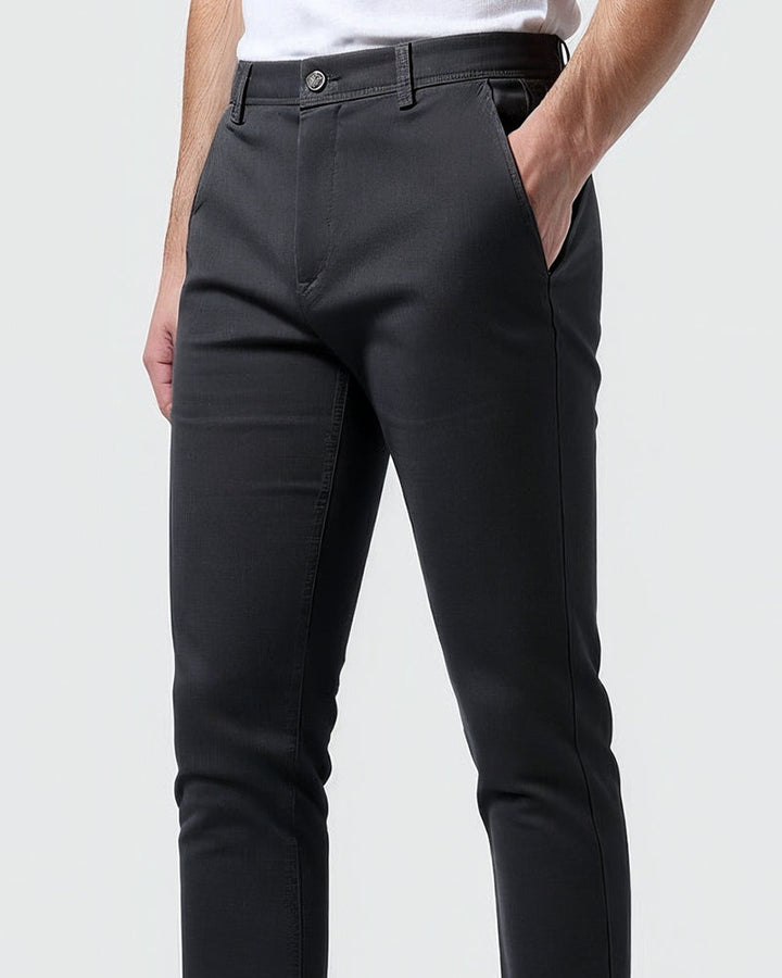 Full-length view of men's tapered chinos on a model