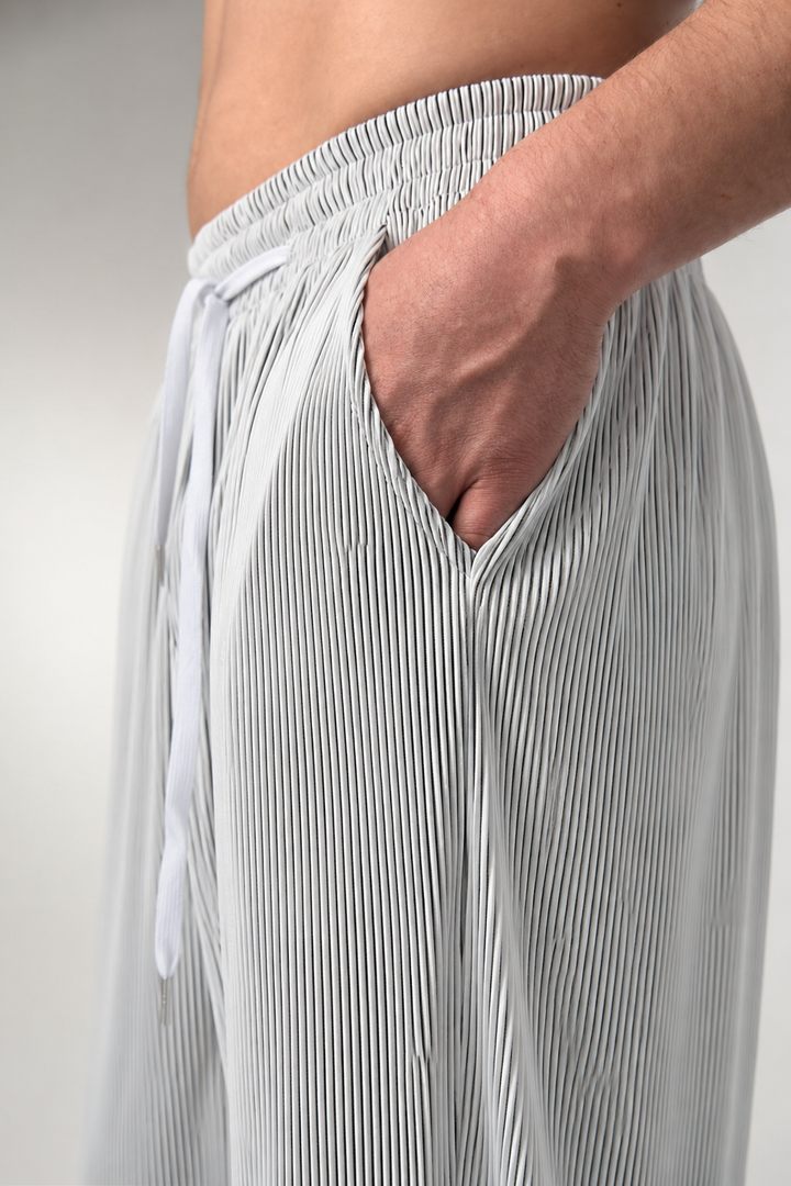 Three-quarter view of men's striped trousers highlighting the drape and fit