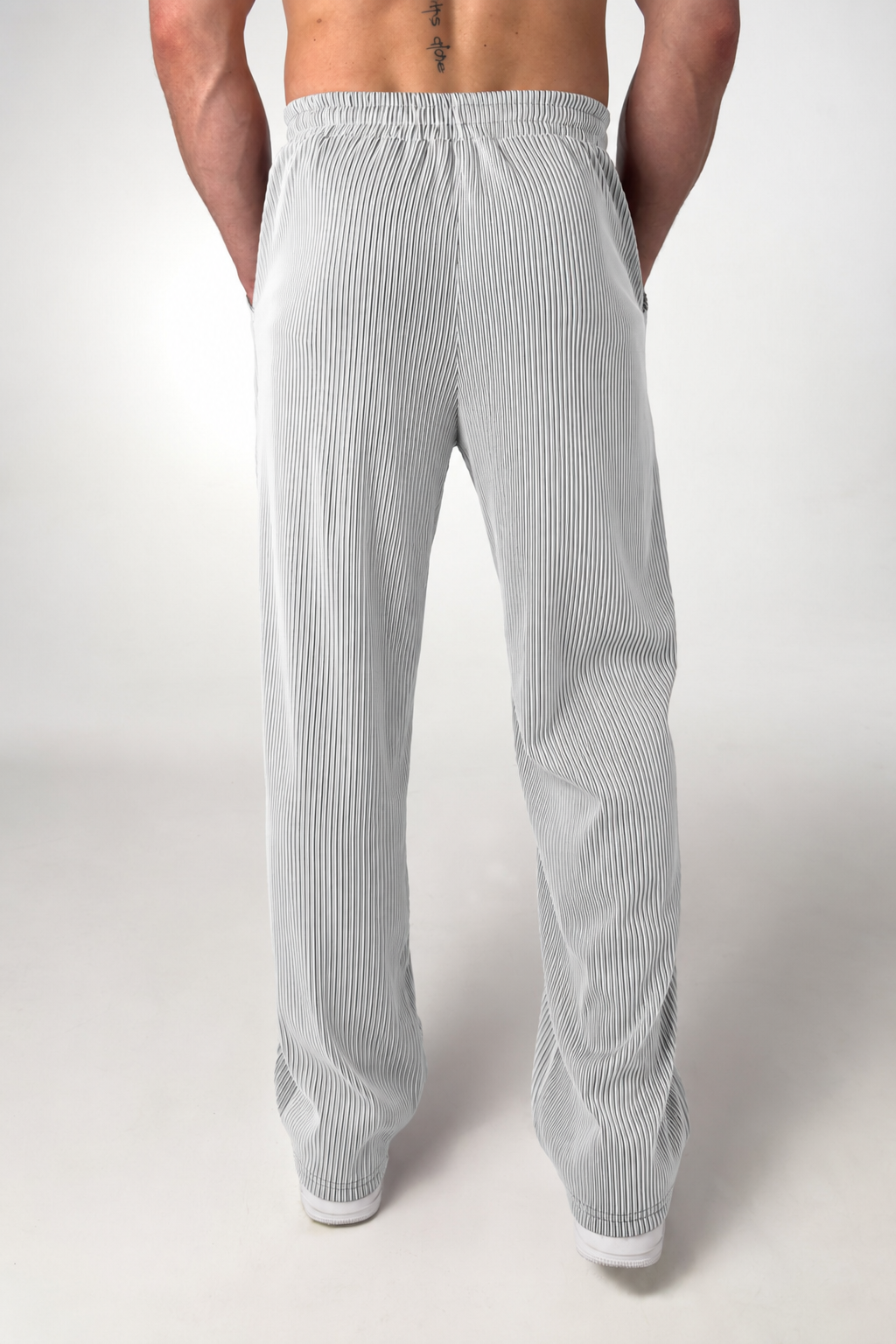 Close-up of the leg and hem on men's straight-leg striped trousers