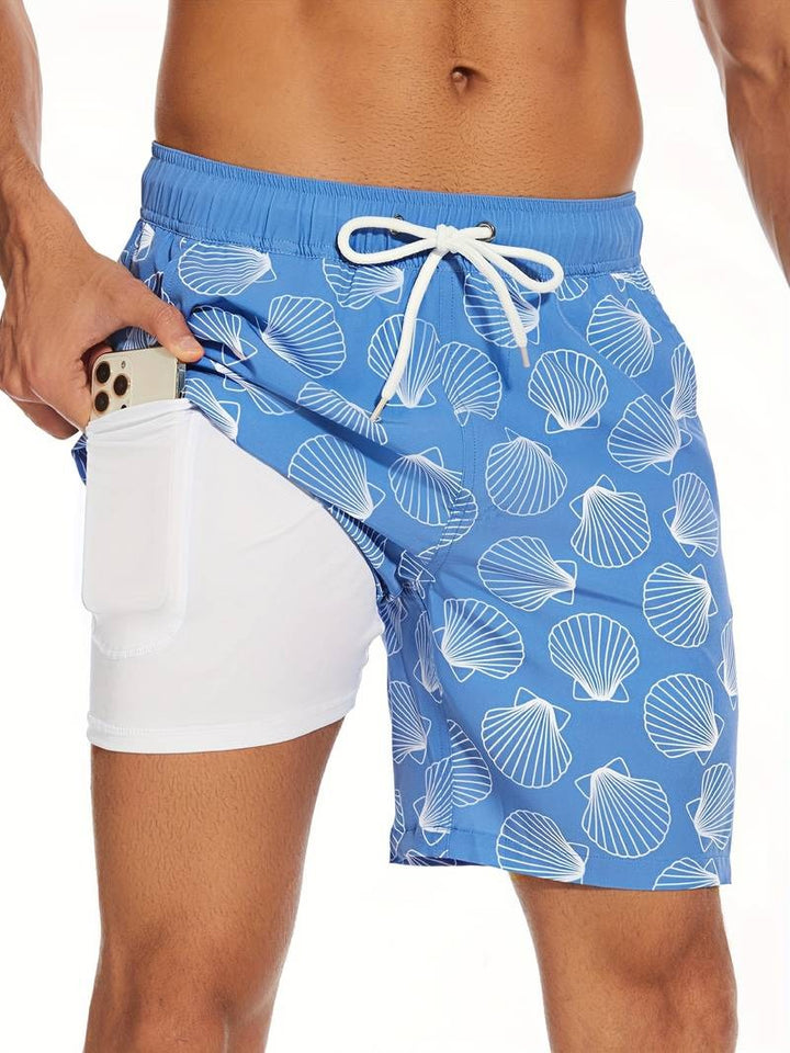 Full-length view of men's relaxed fit flamingo print swim shorts on model