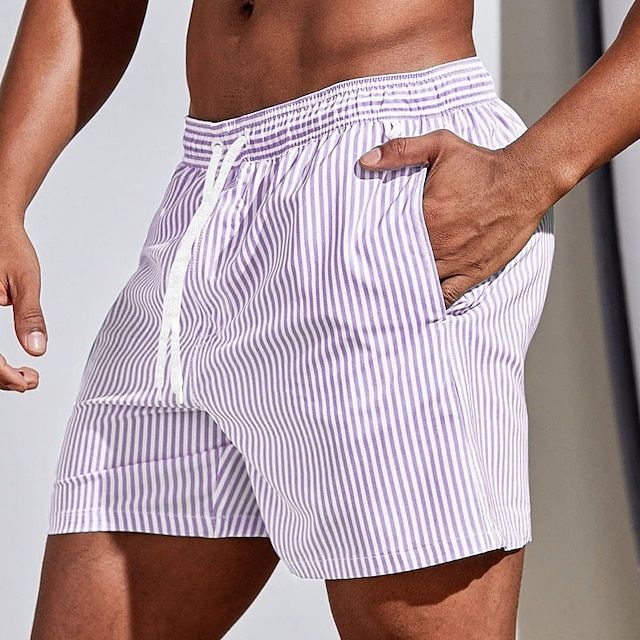 Close-up of drawstring waistband on men's striped swim shorts