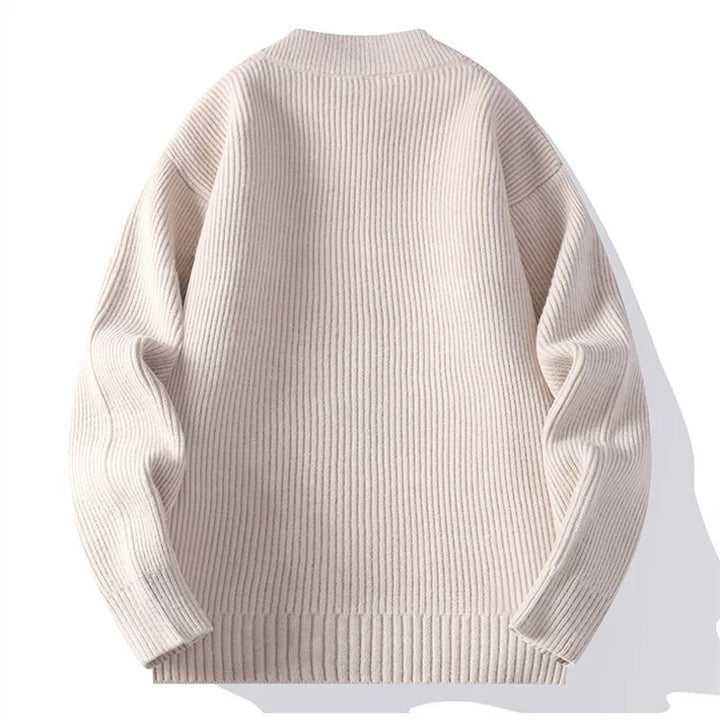 Detailed view of the cardigan's ribbed knit front and long sleeves