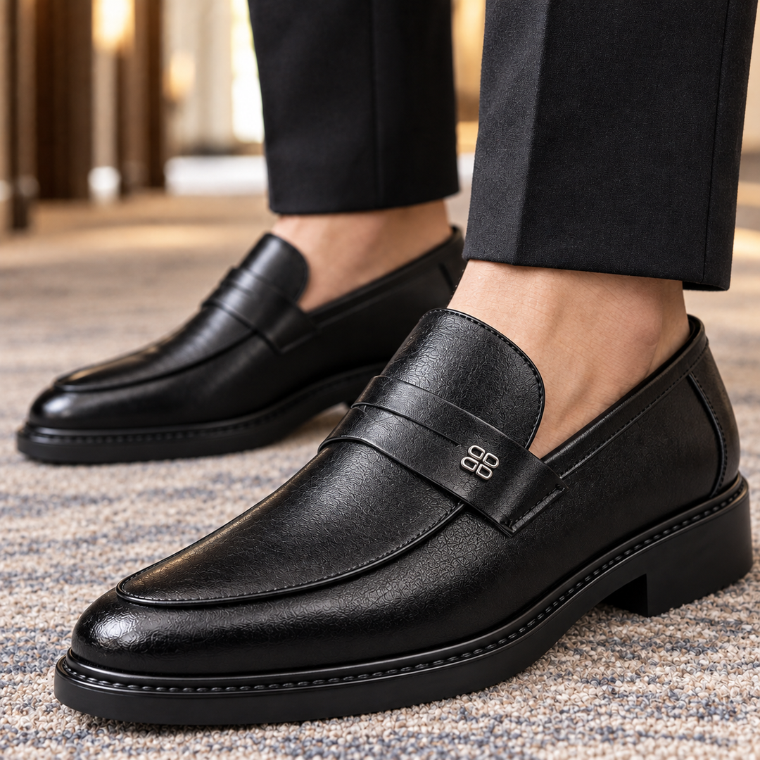 Pair of men's leather loafers displaying the apron toe design
