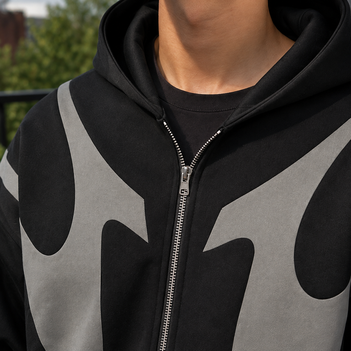 Close-up of the contrast panel detail and front zip on a men's hoodie