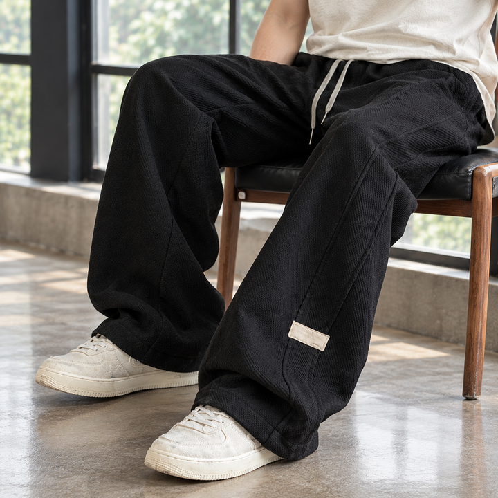 Close-up of the textured fabric on men's wide leg trousers