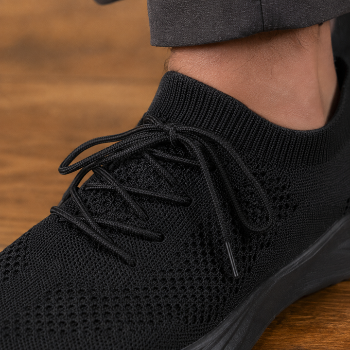 Pair of men's knit sneakers displayed together in a clean product view