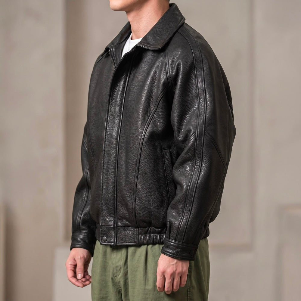 Close-up of the collared leather jacket showing its front zip