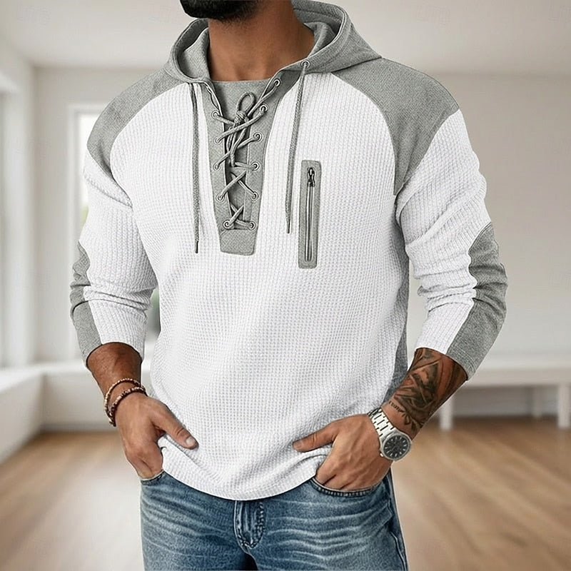 Detail of the lace-up neckline on the hooded jumper