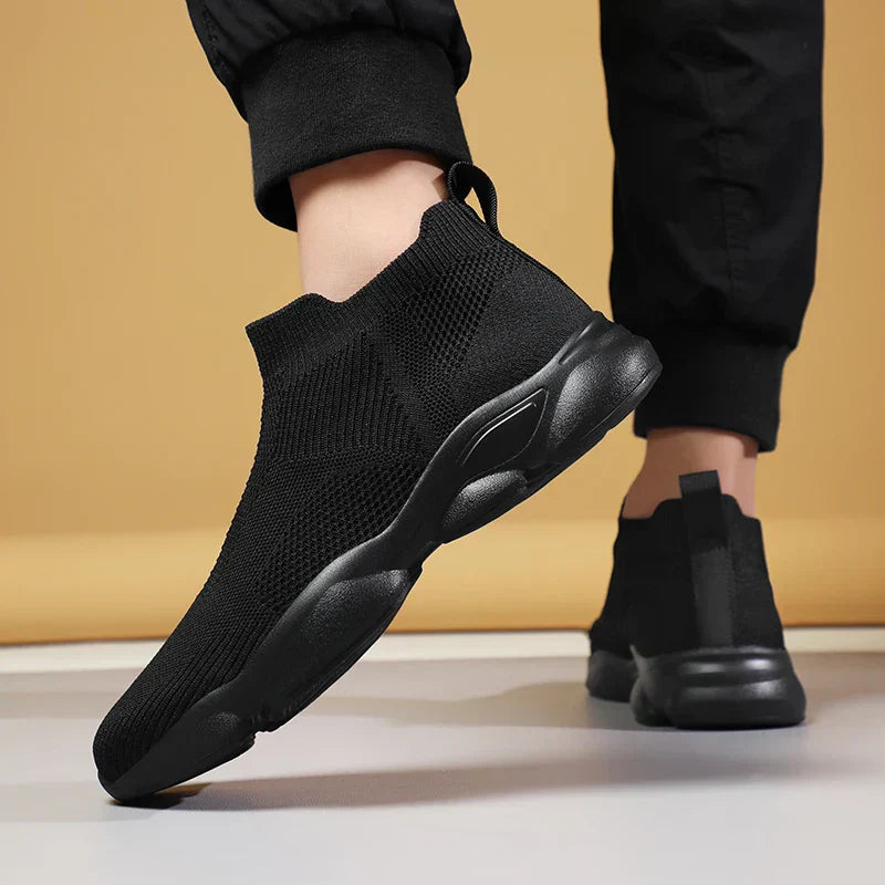 Three-quarter view of black men's high-top sock trainers with sporty silhouette