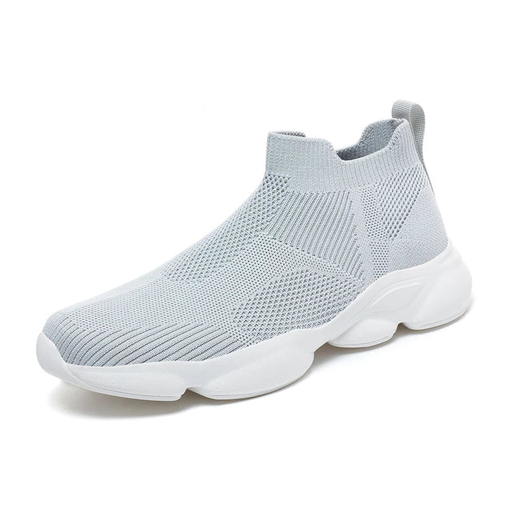 Side profile of black knit sock sneakers for men with white sole contrast