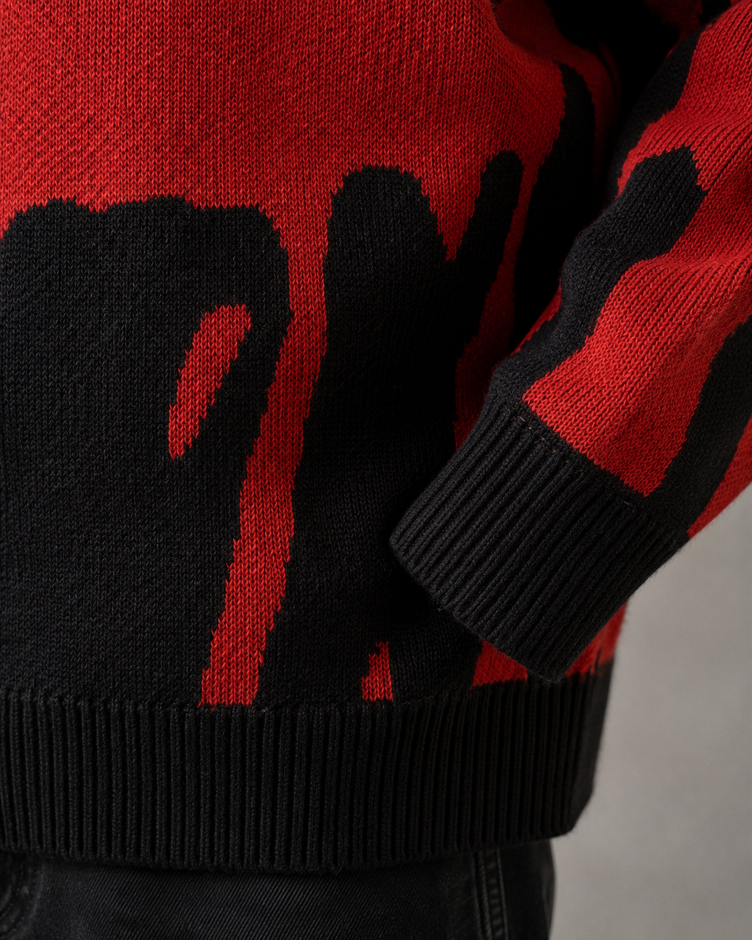 Close-up of the abstract knitted pattern on a men's jumper