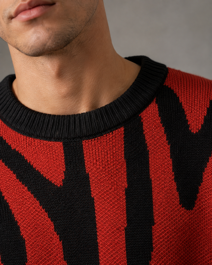 Men's abstract knit jumper showing its relaxed drop-shoulder fit