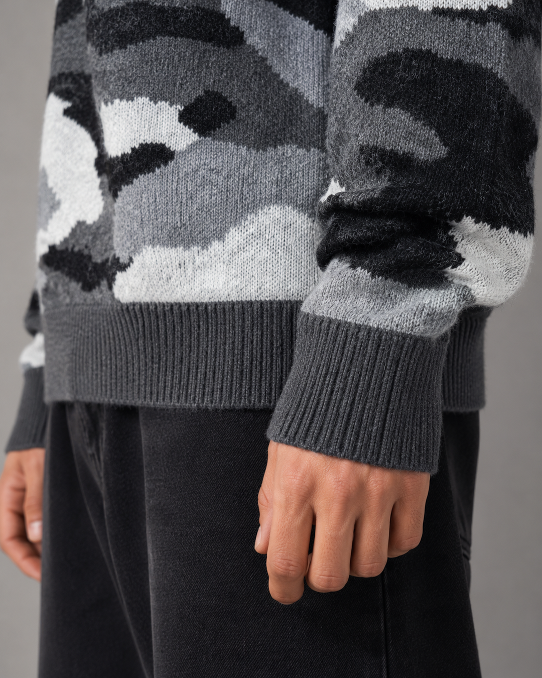 Close-up of the knitted camouflage pattern and crew neck on the men's jumper