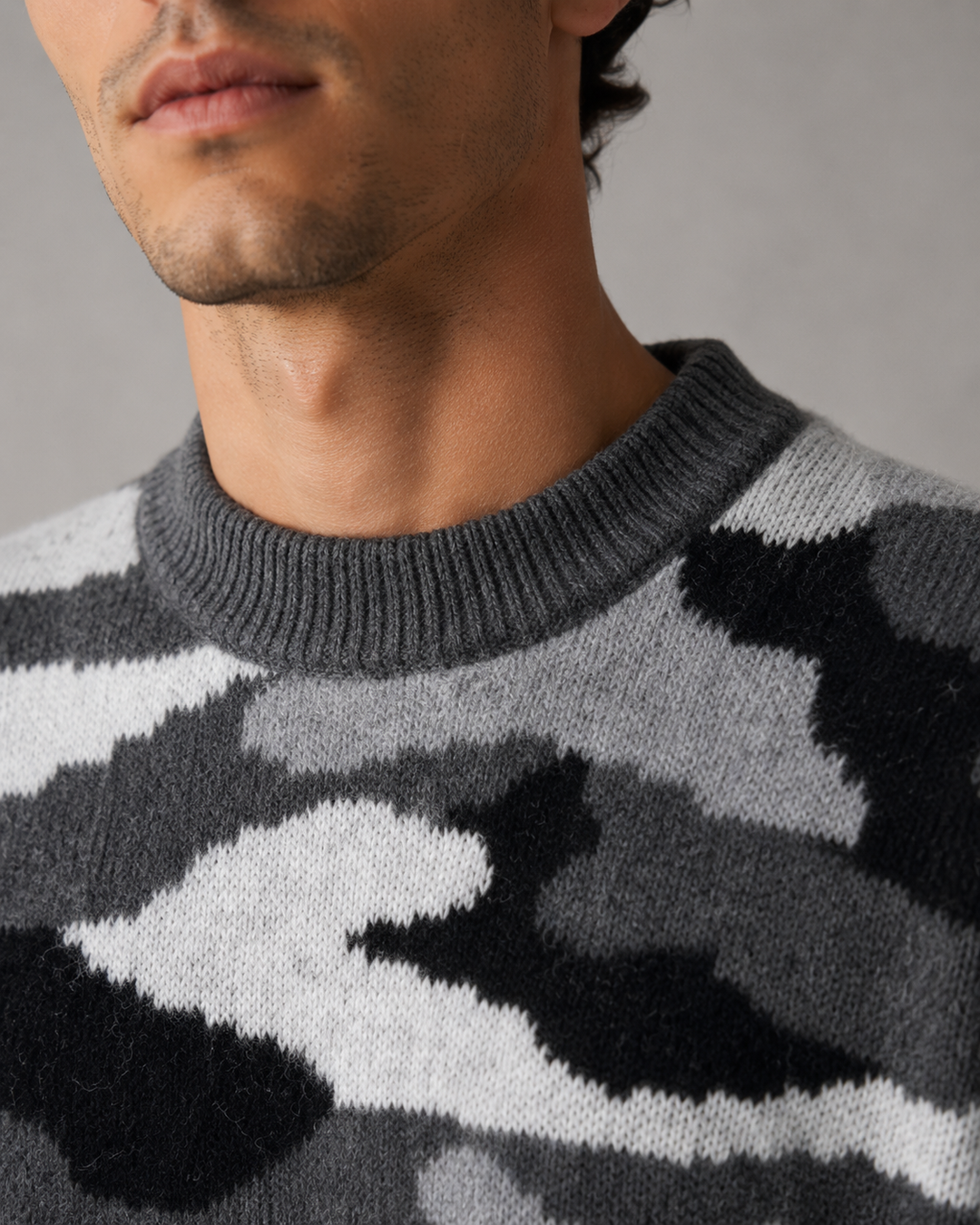Men's camouflage knit jumper styled with casual trousers for an everyday look