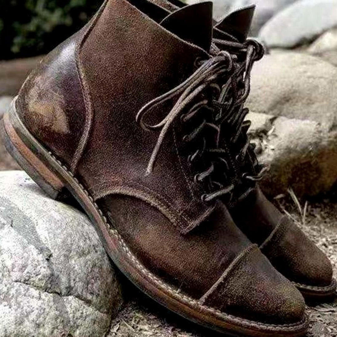 Side view of men's ankle-high winter boots in a leather-look finish