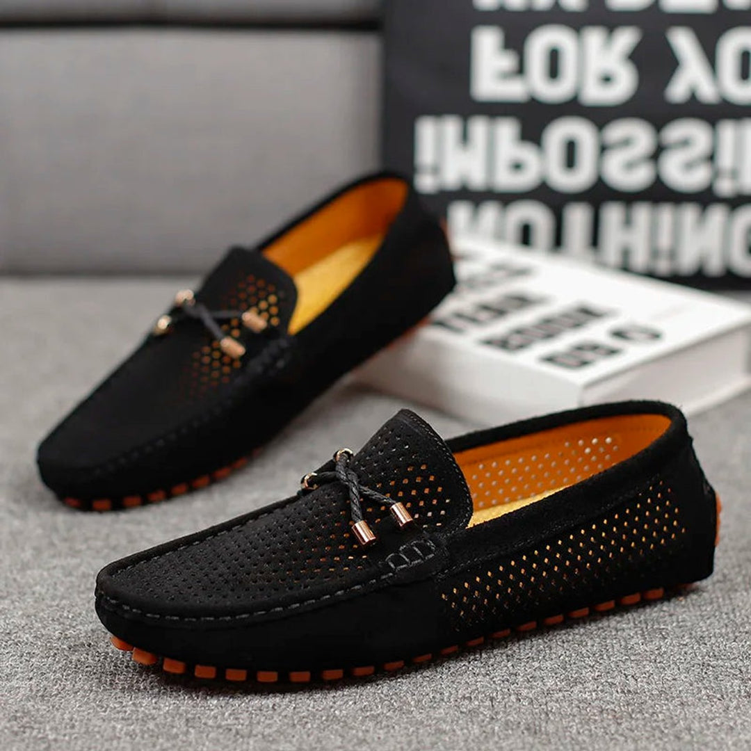 Underside of men's perforated suede driving loafers