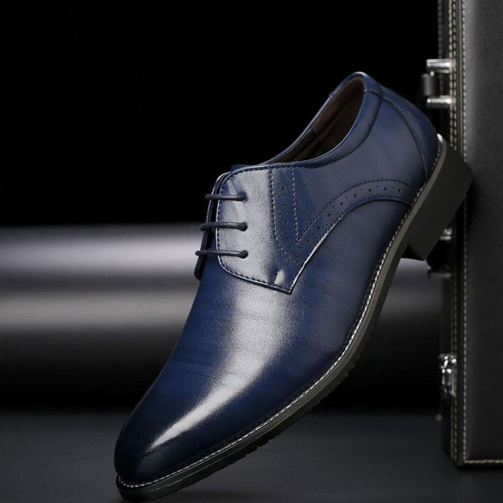 Side view of men's polished leather brogue dress shoes with lace-up fastening