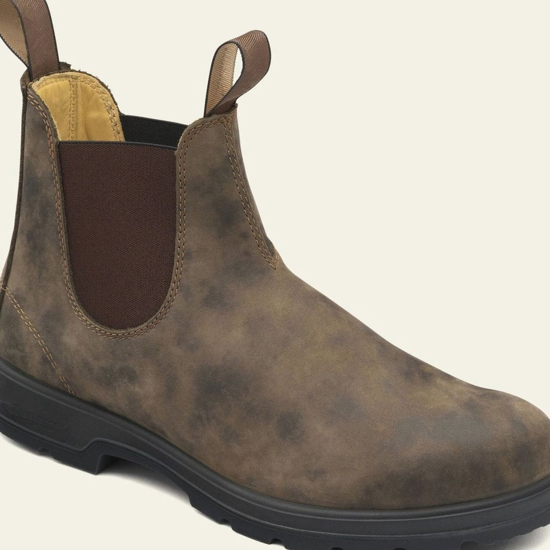 Close-up of the pull tab and elastic side panel on a Chelsea boot
