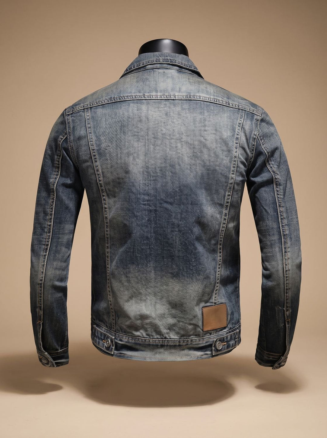 Back view of a men's vintage-washed denim trucker jacket