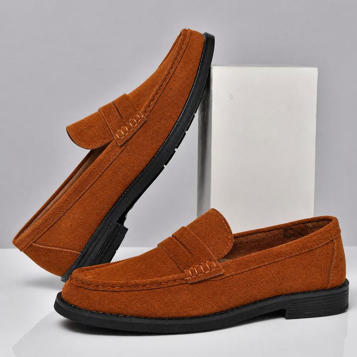 Men's suede penny loafers shown from the side