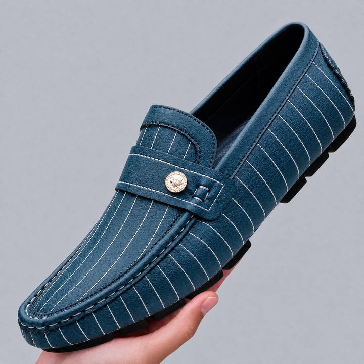 Pair of men's leather loafers with metal detail from the side view