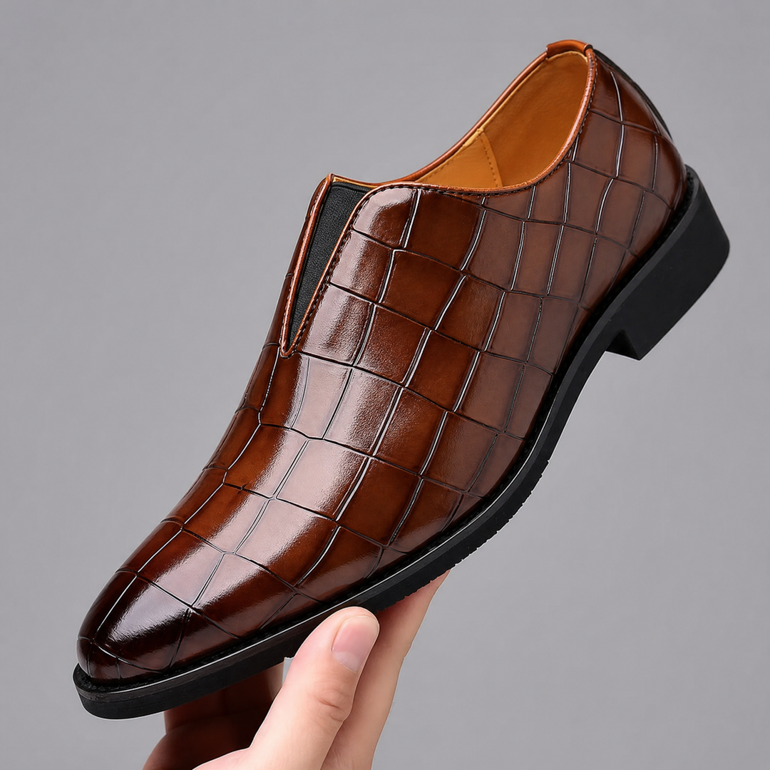 Pair of men's leather loafers displaying the croc-embossed finish