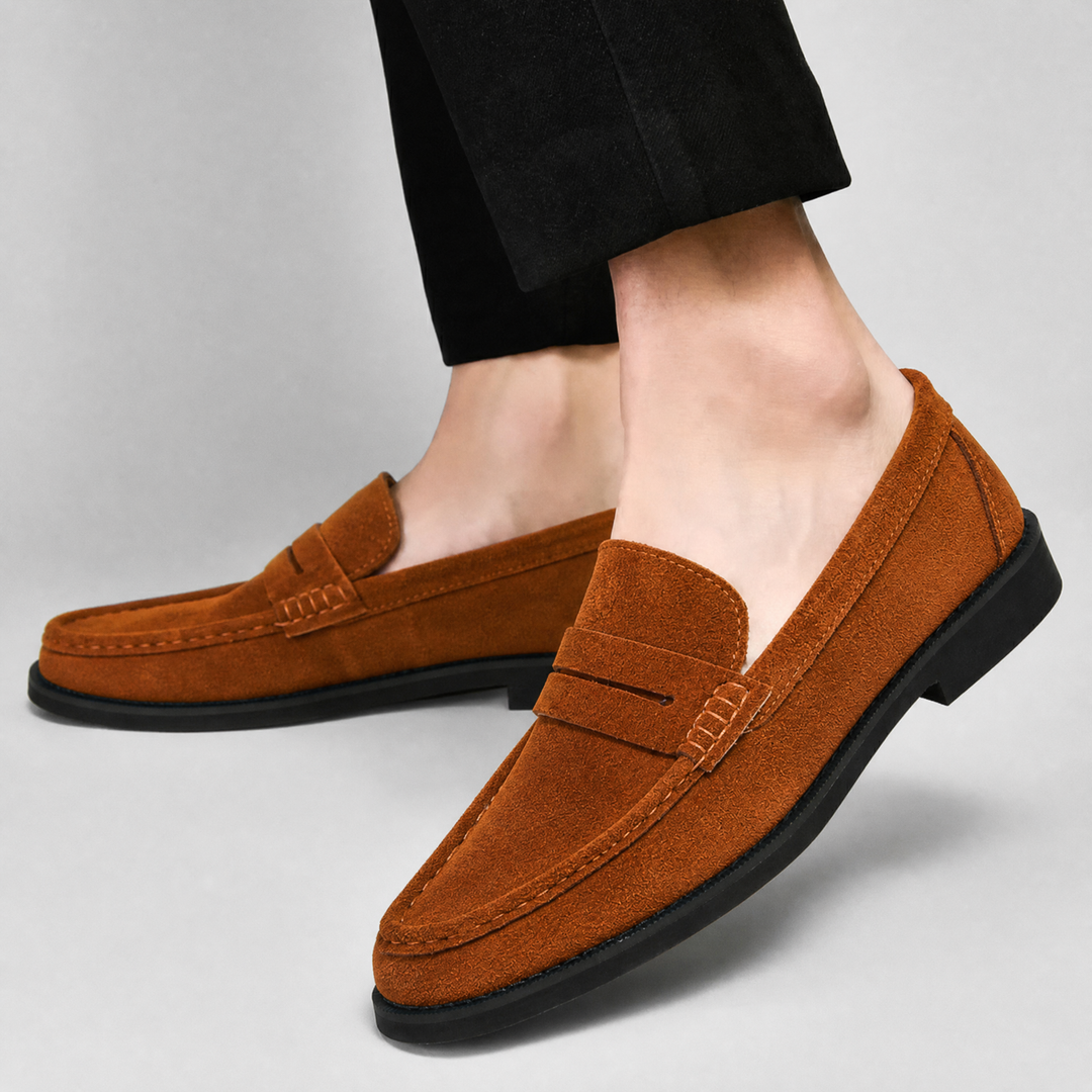 Close-up of the penny strap detail on suede loafers
