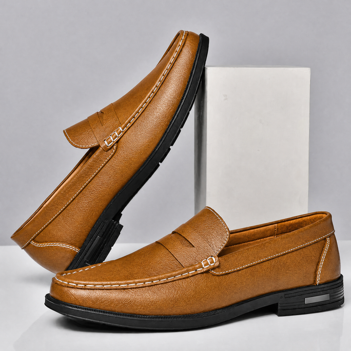 Men's leather penny loafers displaying the classic apron toe