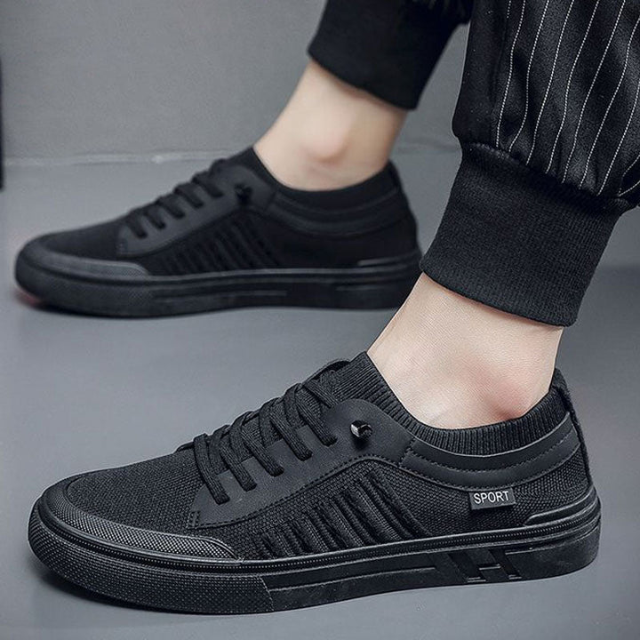 Inner side view of men's breathable slip-on trainers on a plain background