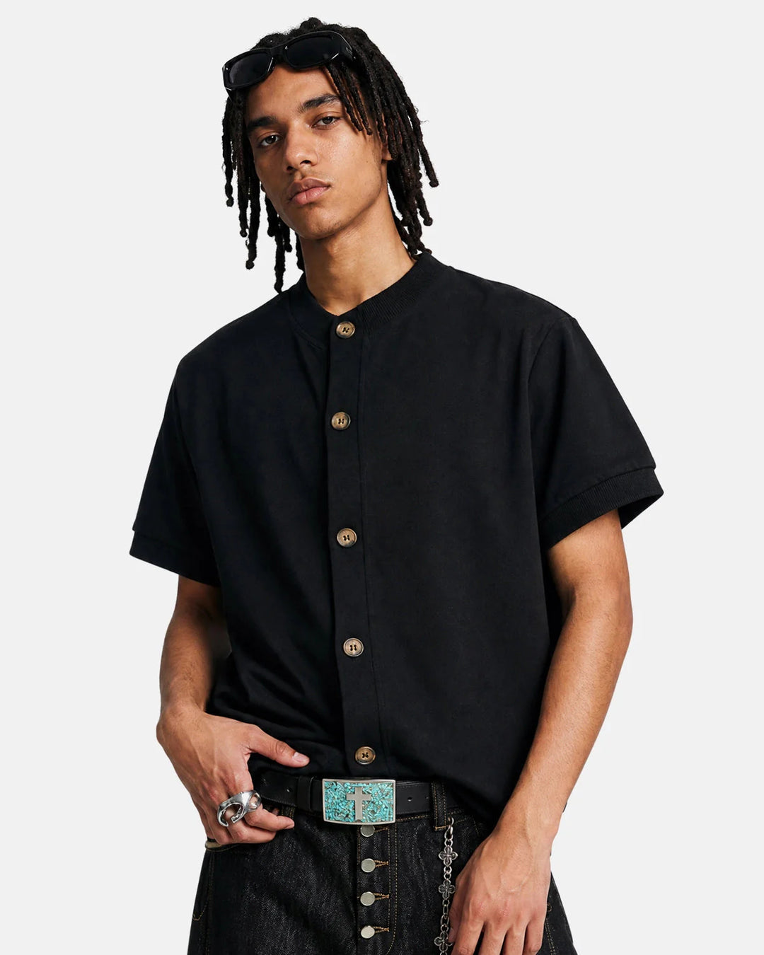 Men's short sleeve button cardigan displayed in a minimalist studio shot
